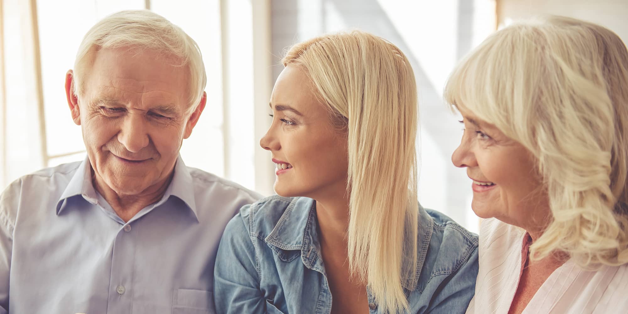 A daughter sitting with her senior parents as they discuss the options of assisted living.